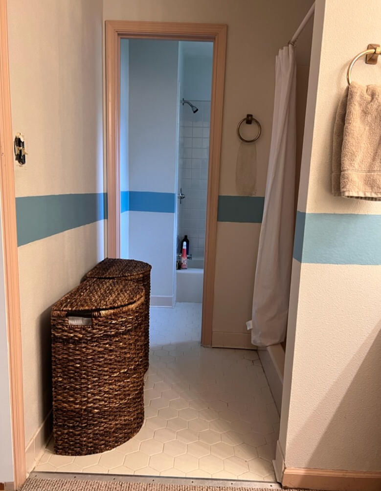 The existing bathroom featured a compartmentalized layout, builder-grade finishes, and limited functionality.